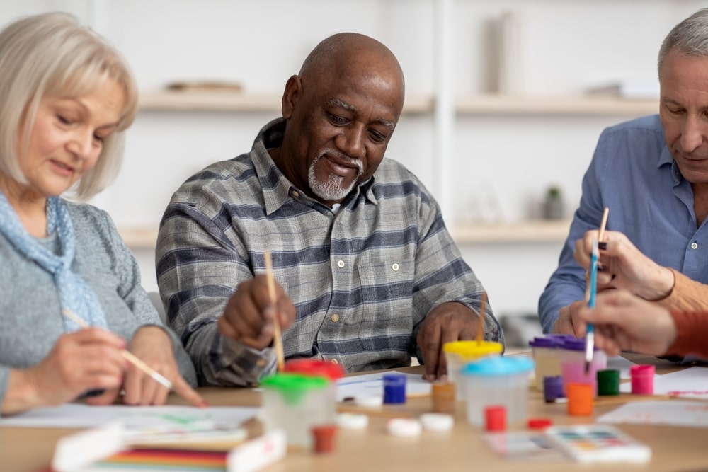 group of people in hospice doing art therapy