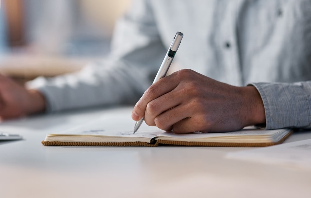 person writing in a notebook