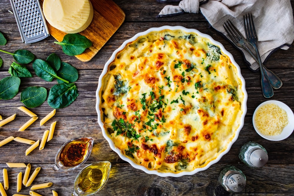 baked pasta casserole on a table surrounded by ingredients