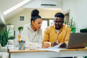 Man and woman sitting at home and reviewing documents together