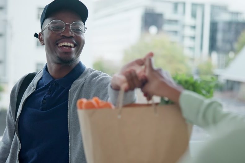 man dropping off groceries for a friend