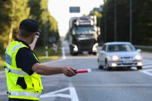 policeman directing traffic for a funeral procession