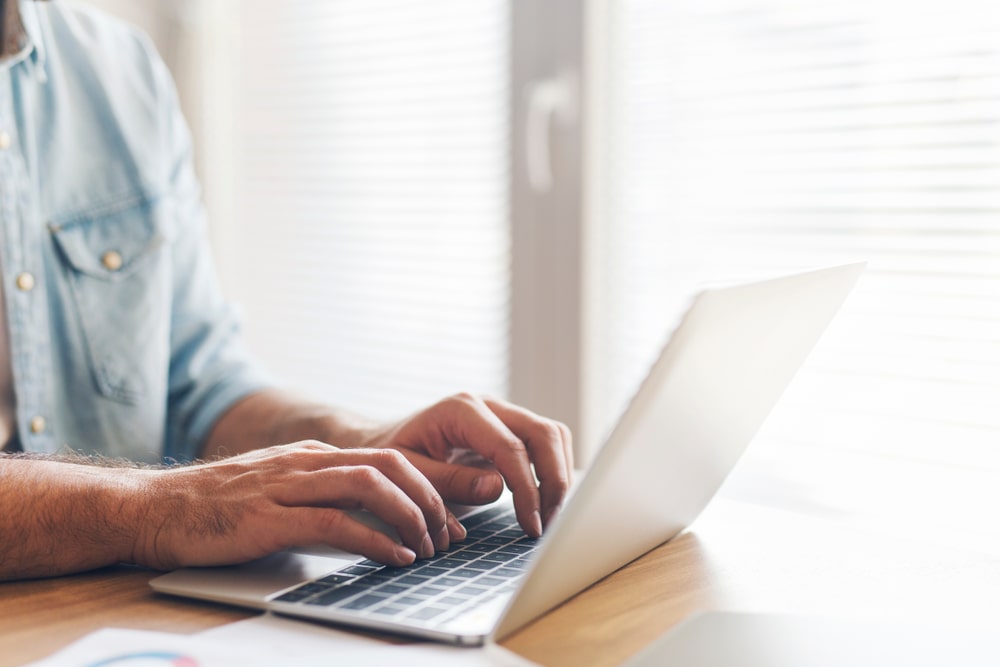 person typing on a laptop