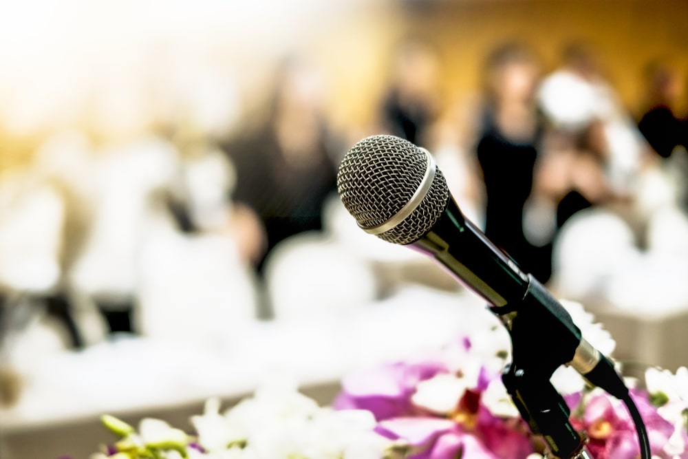 microphone and flowers at a funeral ready for a eulogy