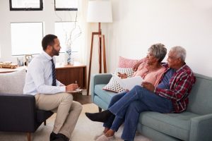 Mature couple sitting in the comfort of their home talking to a preplanning specialist; funerals aren't one-size-fits-all