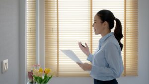 woman rehearsing a eulogy in front of her mirror