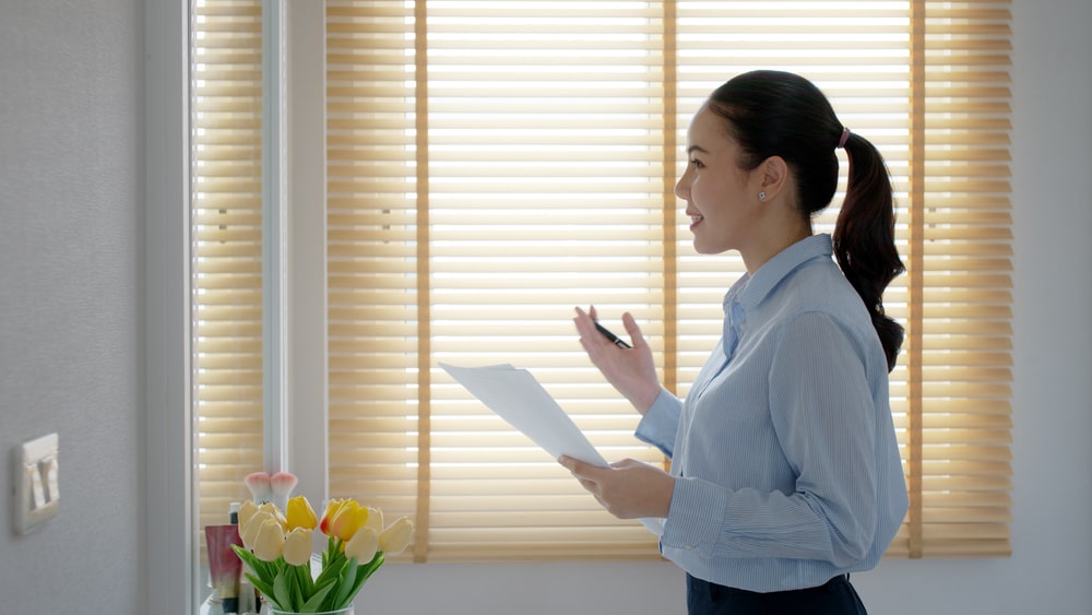 woman rehearsing a eulogy in front of her mirror