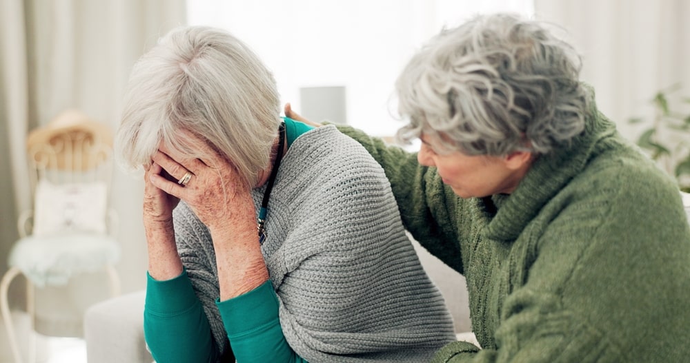 Family member comforting a loved one who is experiencing depression; mature couple