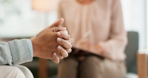 Two people sitting in a counseling session; dealing with grief & depression