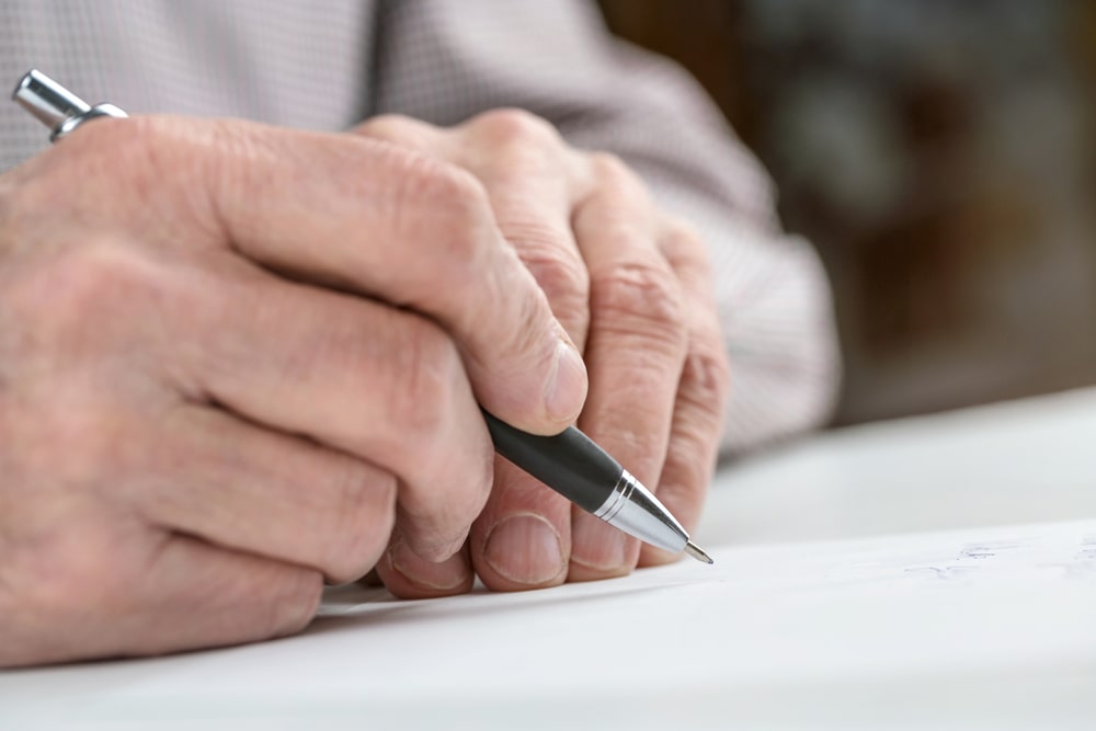 Person writing a condolence letter to a grieving friend