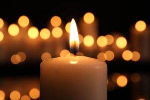 Lit candle of remembrance