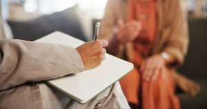 Grief counselor listening to a client