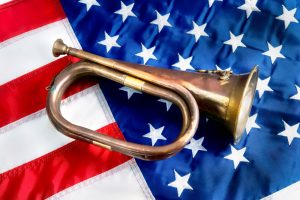 Bugle resting on top of an American flag