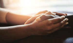 Comfort, two people holding hands