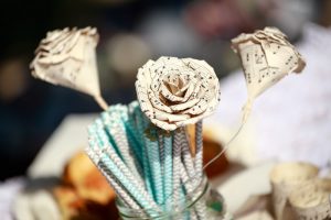 Flowers made out of sheet music placed in a vase.