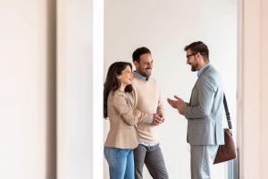 A couple talking to a businessman
