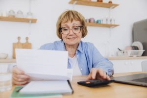 An older woman using a calculator