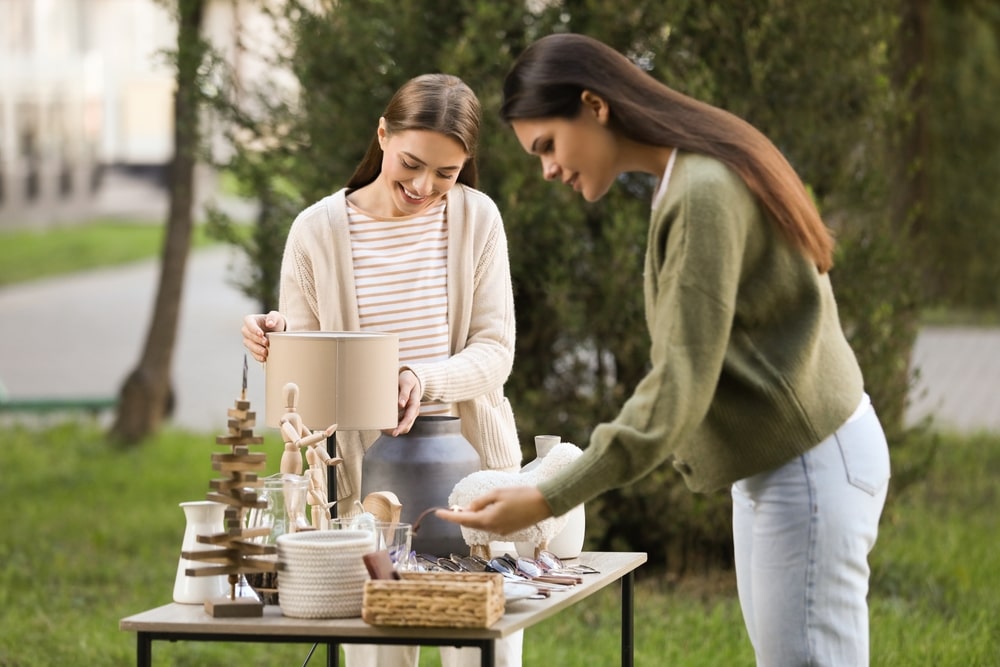 Two girls looking at an estate sale's items
