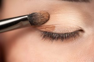 a makeup brush applying makeup on an eyelid