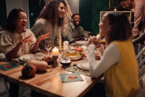 people seated around a table laughing