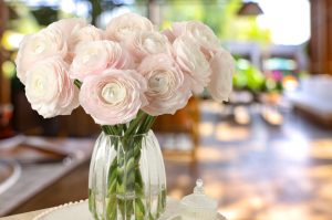 Pink flowers in a vase sitting on a table