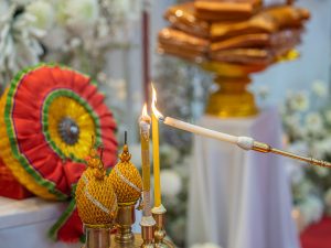 Candles being lit during a traditional Thai Buddhist funeral ceremony
