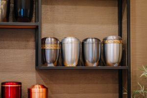 Metal urns lined up together on a shelf