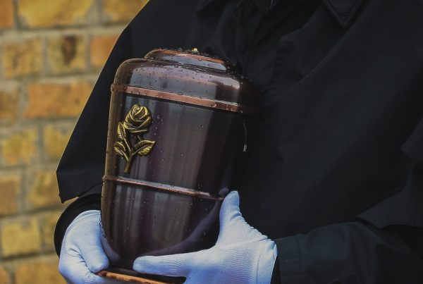 A decorative urn being carried reverently