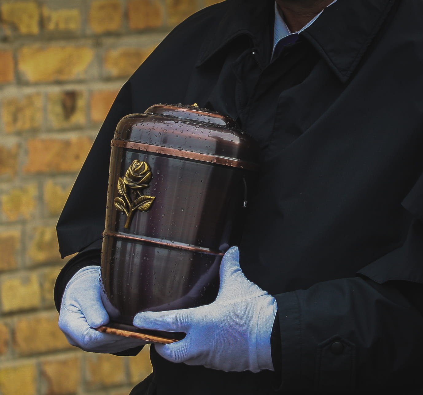 A decorative urn being carried reverently