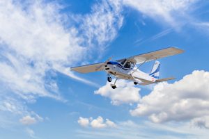 small charter plane flying in the sky