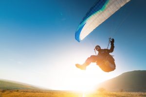 paraglider ready to land at sunset