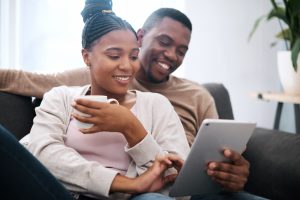 Couple looking at ipad together on a couch