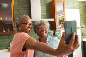 Two ladies taking a selfie in a kitchen