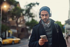 Man walking down a street and listening to music