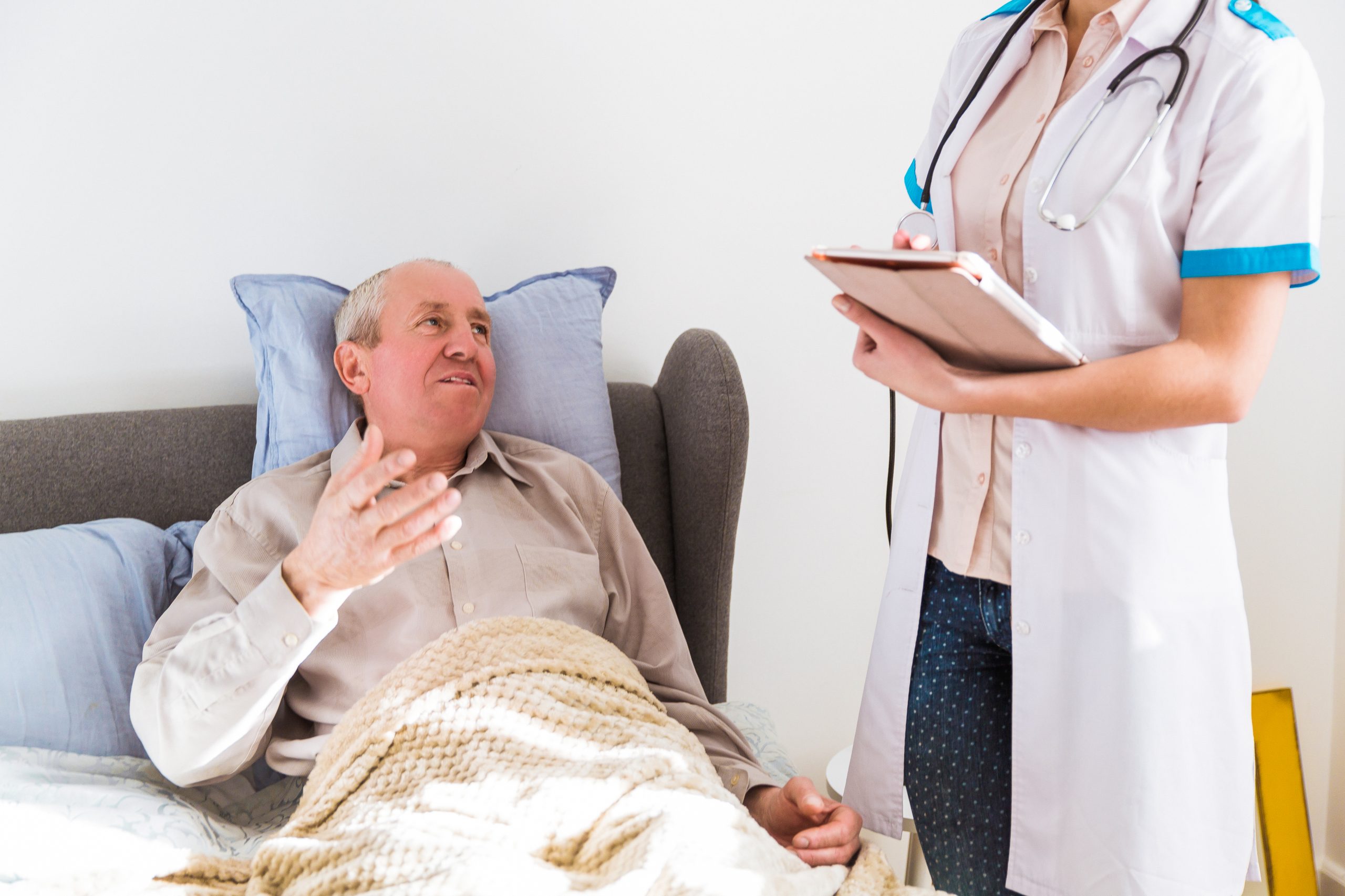 A hospice patient talking to a hospice caretaker