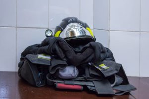 Firefighter gear stacked on a table.