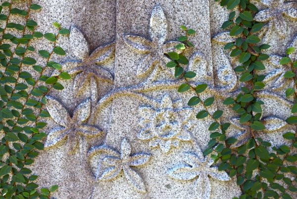 Flower and vine design carved into headstone
