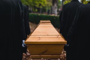People carrying a wooden casket
