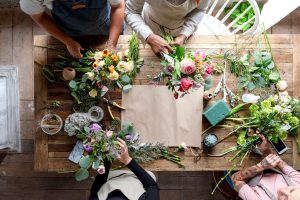 People arranging flowers together