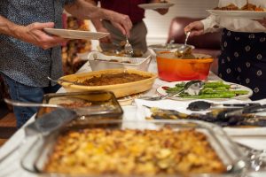 People serving themselves at a potluck