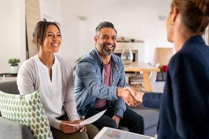 Middle-aged couple talking with estate planning attorney at their home