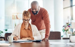 Husband and wife reviewing estate planning documents together while at home