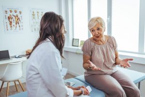 Senior woman talking with her doctor about medical care wishes