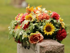 orange and yellow flowers placed on a headstone