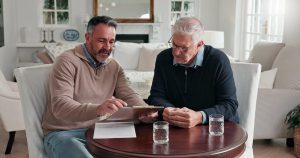 Senior man talking about estate planning with son